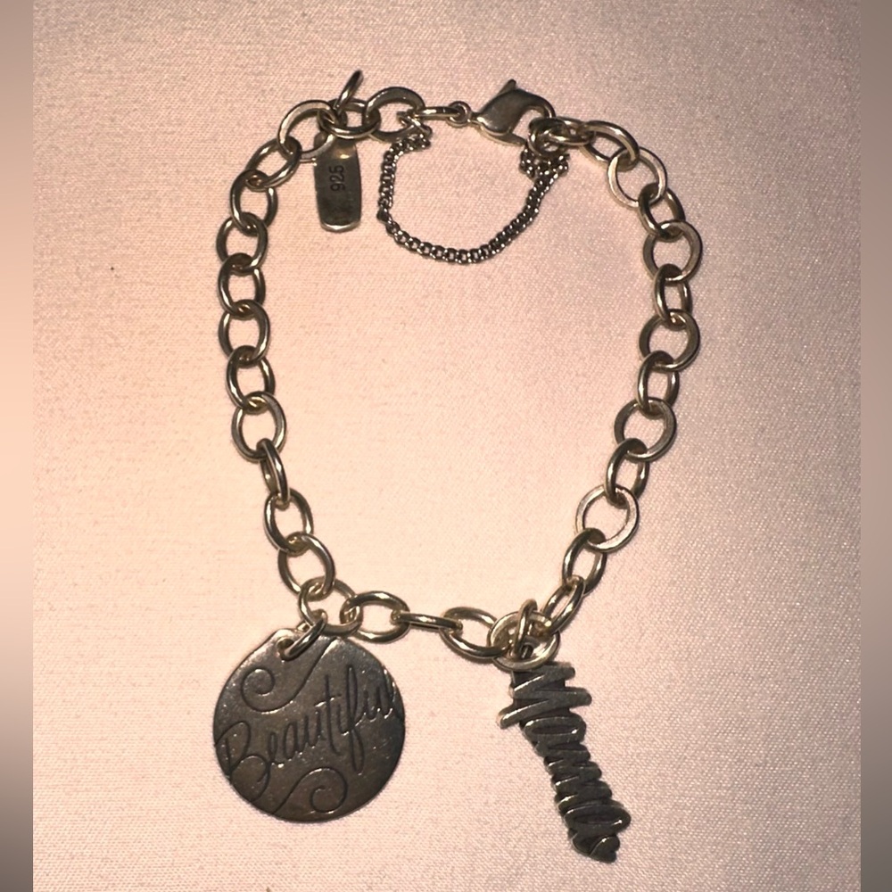 James Avery Charm Bracelet w/ 2 charms, one in which is retired.